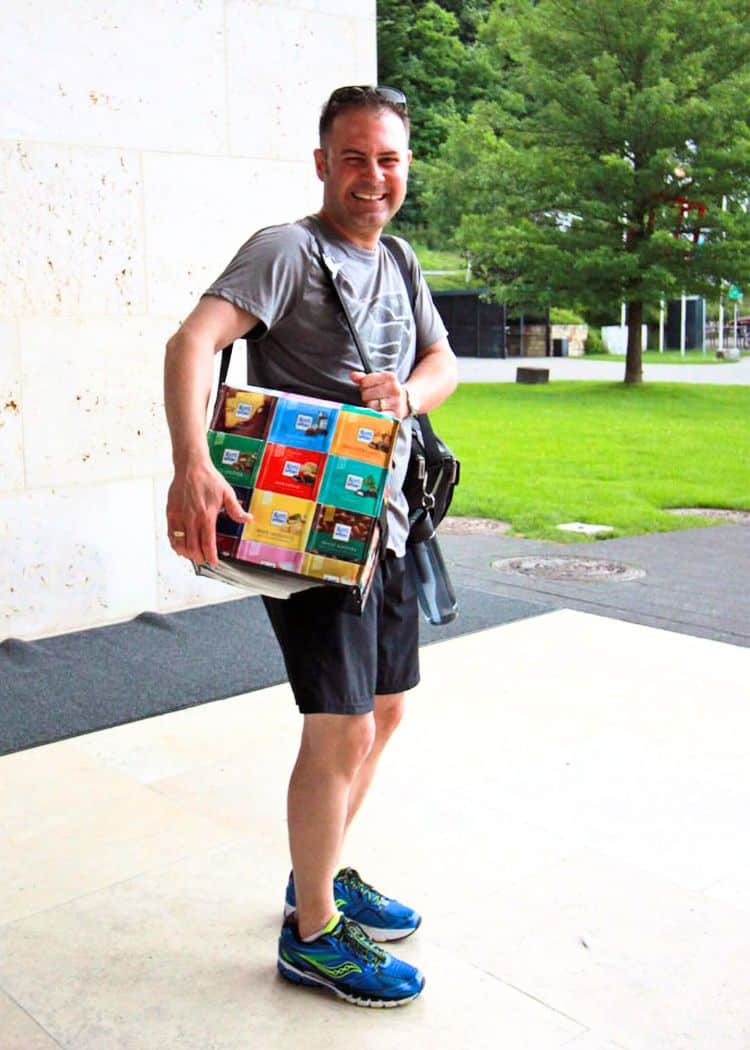 Hubby-holding-case-of-chocolate-and-grinning