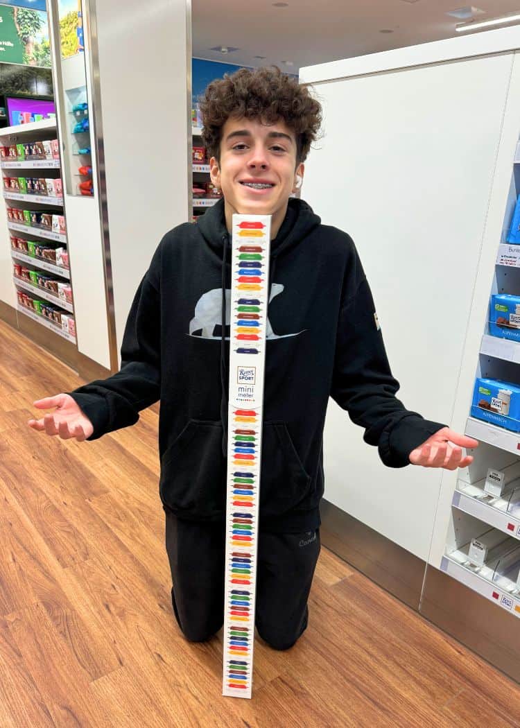 Older Boy measuring his height with chocolate