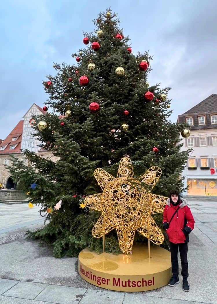 Reutlingen Christmas Market - Boy with snowflake sculpture under Christmas tree