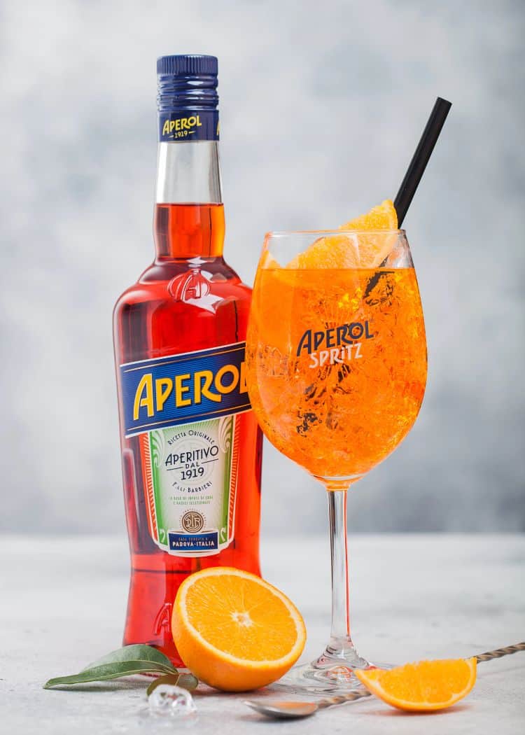 Bottle of Aperol with glass of Aperol spritz